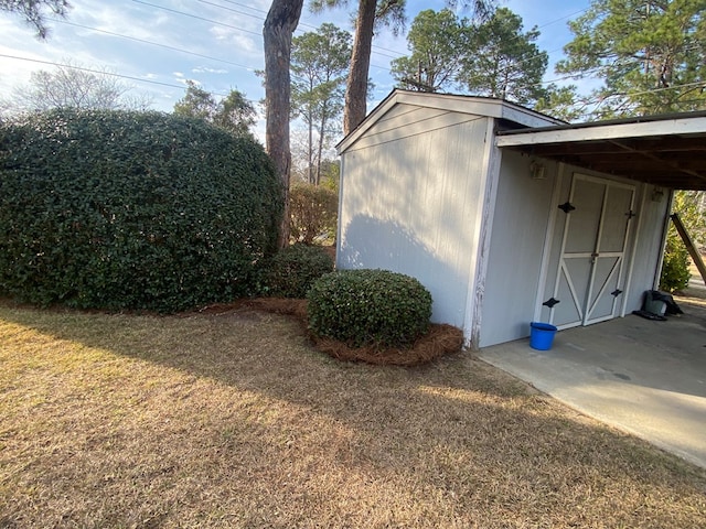 view of home's exterior with a yard and a shed