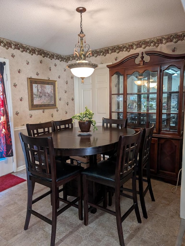 dining space with a textured ceiling