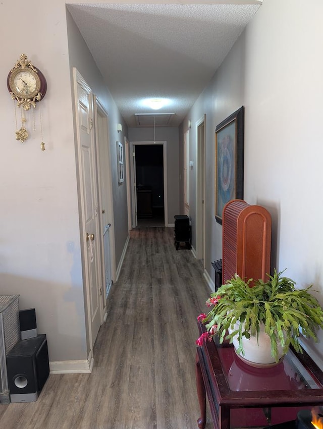 corridor featuring dark hardwood / wood-style floors and a textured ceiling