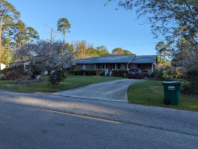 ranch-style home with a carport and a front lawn