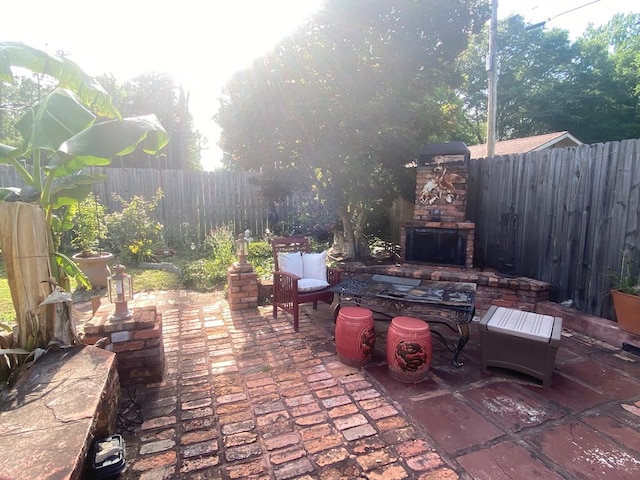 615 E 28th Ave, Cordele, GA 31015 - view of patio featuring exterior fireplace and a fenced backyard