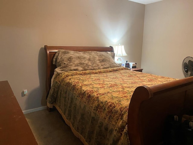 bedroom with dark colored carpet