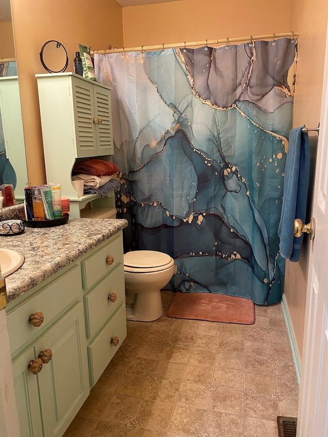 bathroom with vanity and toilet