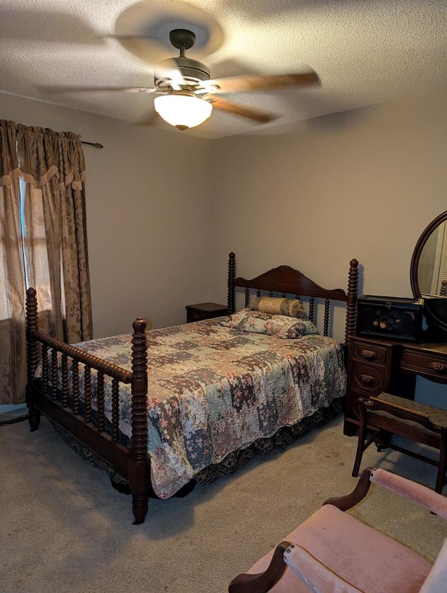 bedroom with carpet floors, a textured ceiling, and ceiling fan