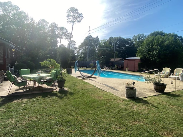 615 E 28th Ave, Cordele, GA 31015 - view of swimming pool with a patio area, a storage shed, a water slide, an outbuilding, and a lawn