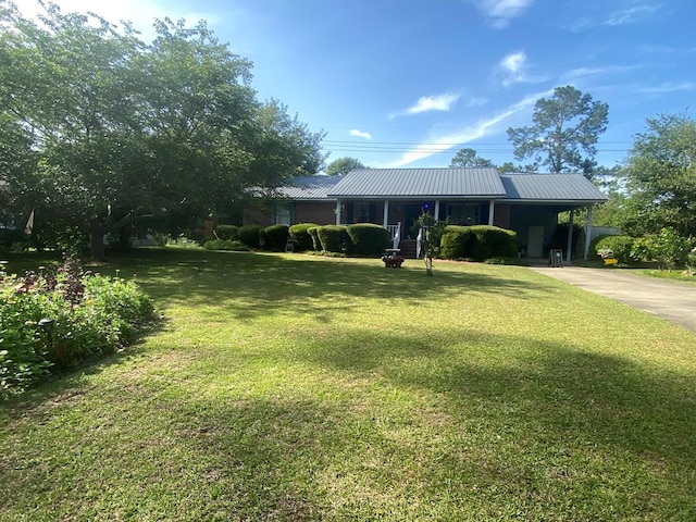 615 E 28th Ave, Cordele, GA 31015 - ranch-style home with concrete driveway, a front yard, and metal roof