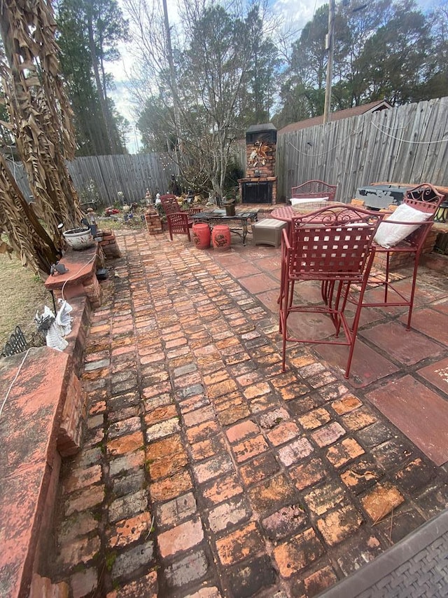 view of patio / terrace featuring an outdoor stone fireplace