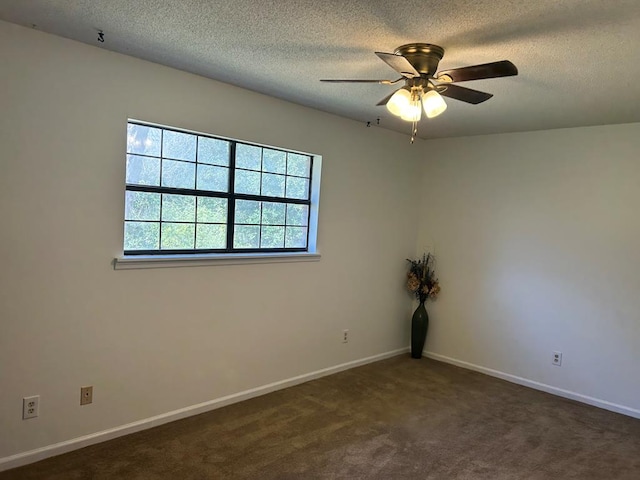 empty room with ceiling fan, carpet floors, a textured ceiling, and baseboards