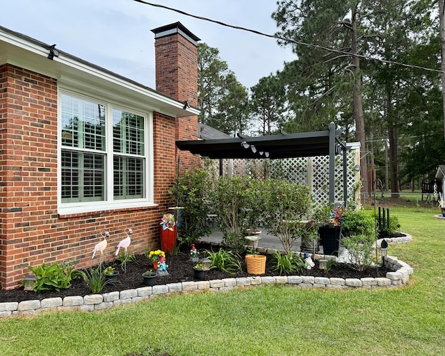exterior space featuring a lawn, brick siding, and a chimney