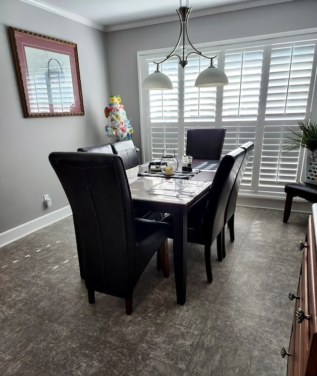 dining room featuring crown molding, baseboards, and a wealth of natural light