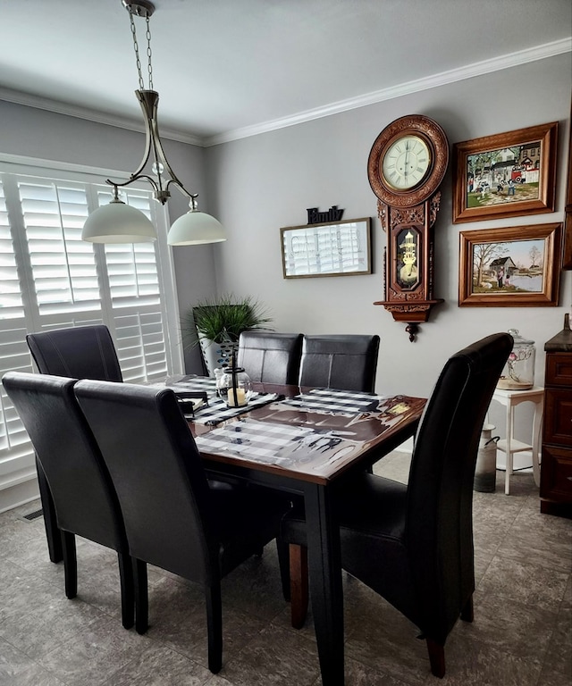 dining space with crown molding