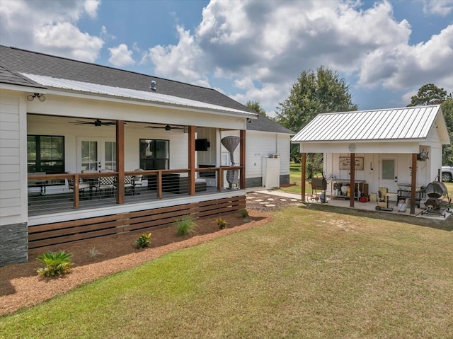 back of house with a yard, a patio, and ceiling fan