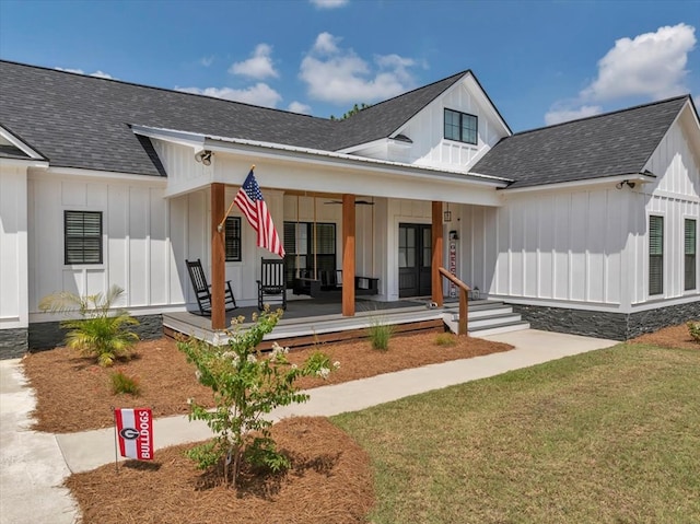 view of front of home with a porch and a front lawn