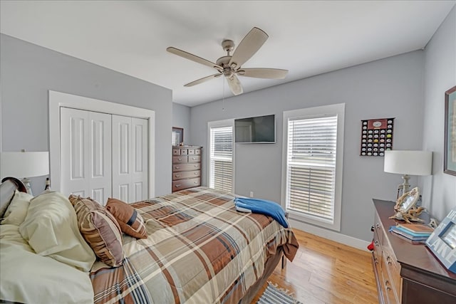 bedroom featuring a closet, ceiling fan, and light hardwood / wood-style flooring