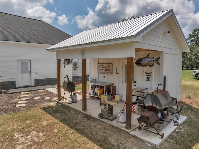 view of patio featuring an outbuilding