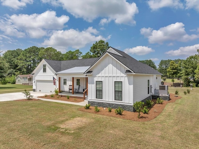 modern farmhouse style home featuring a porch, a garage, and a front lawn