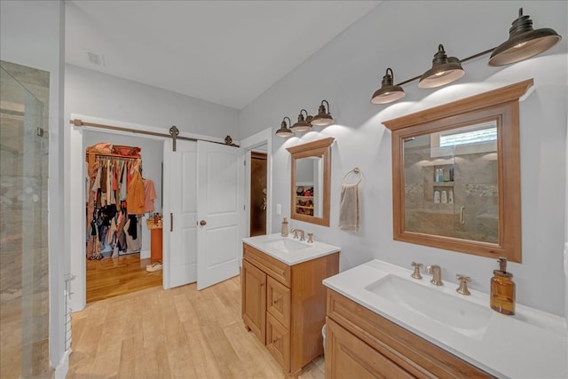 bathroom featuring vanity, hardwood / wood-style floors, and an enclosed shower