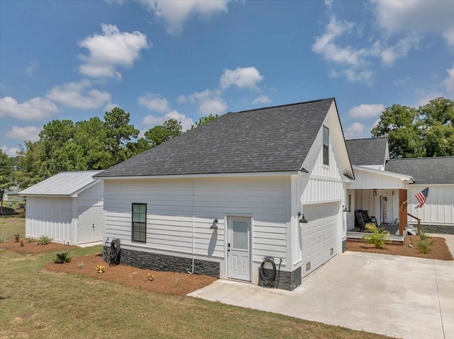 back of property with a yard, a garage, and a porch