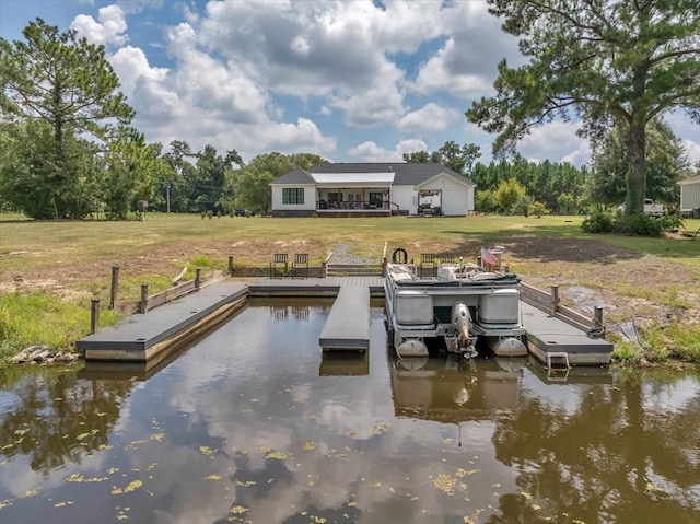 dock area with a water view and a lawn