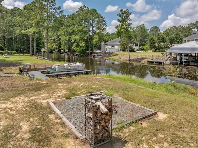 view of yard featuring a dock and a water view