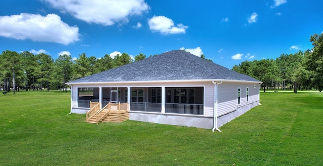 back of house featuring a lawn and a sunroom