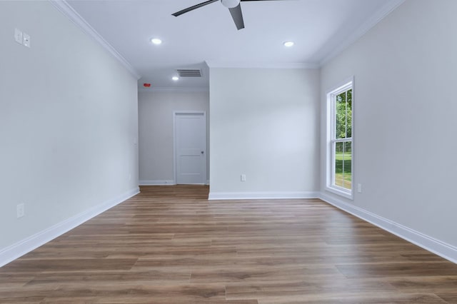 spare room featuring hardwood / wood-style flooring, crown molding, and ceiling fan