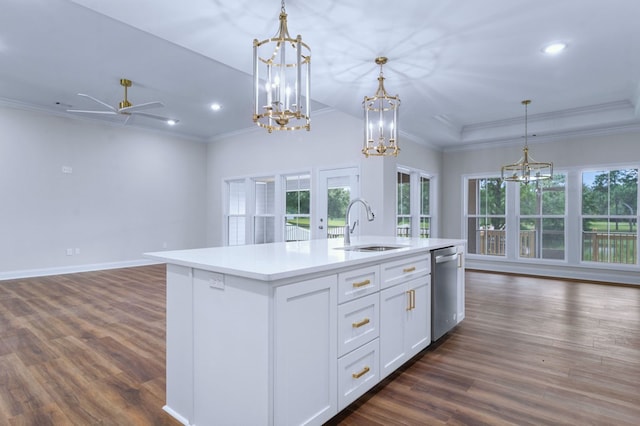 kitchen with pendant lighting, stainless steel dishwasher, an island with sink, and white cabinets