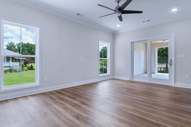 unfurnished room with hardwood / wood-style floors, crown molding, a healthy amount of sunlight, and ceiling fan