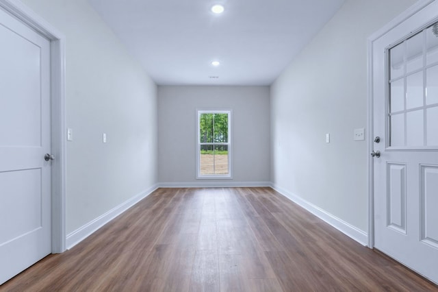 unfurnished room with dark hardwood / wood-style flooring