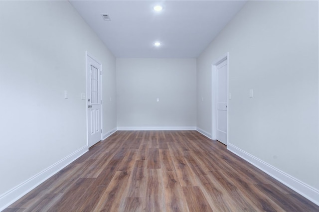 empty room featuring dark hardwood / wood-style flooring