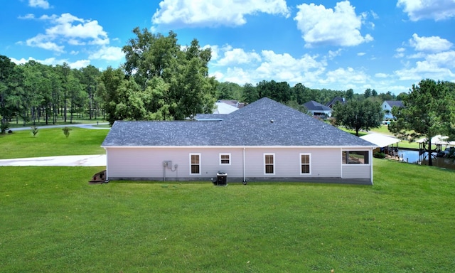 back of property with cooling unit and a yard