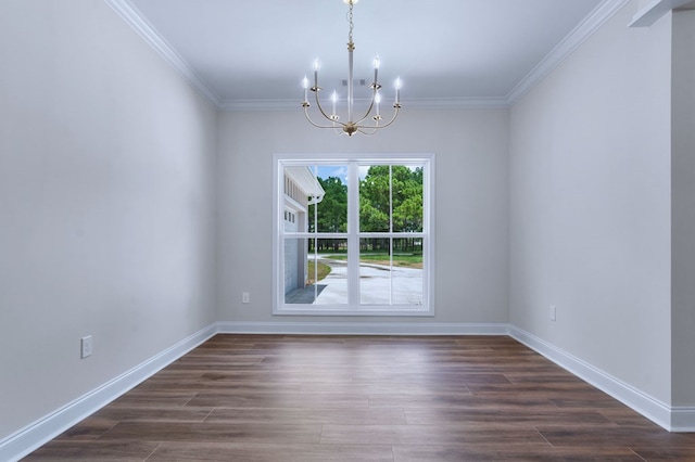 empty room featuring an inviting chandelier, dark hardwood / wood-style floors, and crown molding