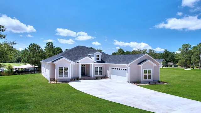 view of front of house with a garage and a front lawn