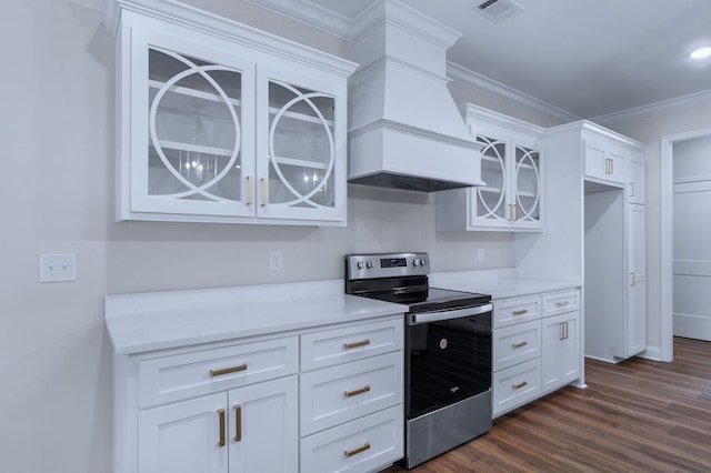 kitchen with dark wood-type flooring, premium range hood, white cabinetry, electric range, and ornamental molding