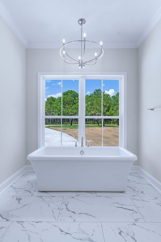 bathroom featuring crown molding, a healthy amount of sunlight, and a tub