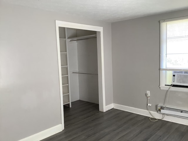 closet with a baseboard heating unit and cooling unit