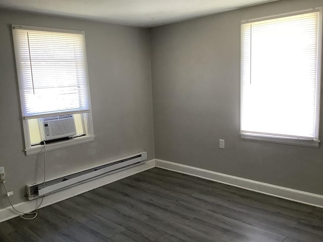 spare room featuring dark wood-style floors, cooling unit, baseboards, and baseboard heating