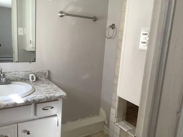 bathroom featuring a stall shower and vanity