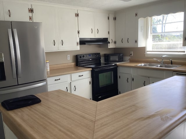 kitchen featuring light countertops, a sink, under cabinet range hood, and black appliances