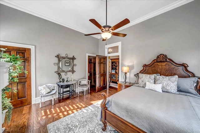 bedroom featuring ceiling fan, hardwood / wood-style floors, and crown molding