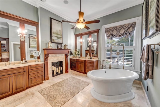 bathroom featuring a washtub, vanity, ceiling fan, and ornamental molding