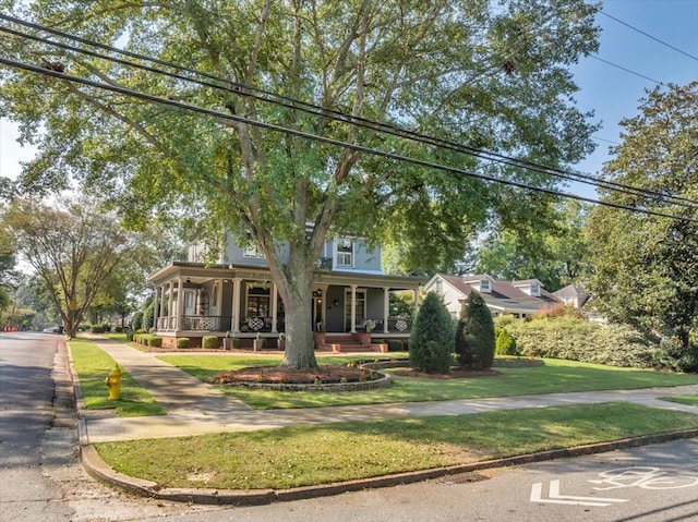 view of front of property with a front yard and a porch