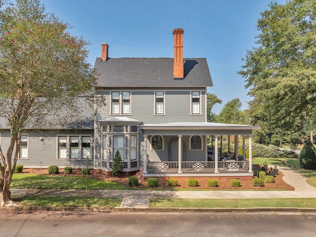 view of front of house featuring a front yard and a porch