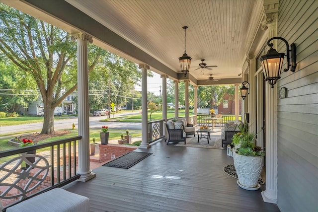 wooden deck with covered porch and ceiling fan