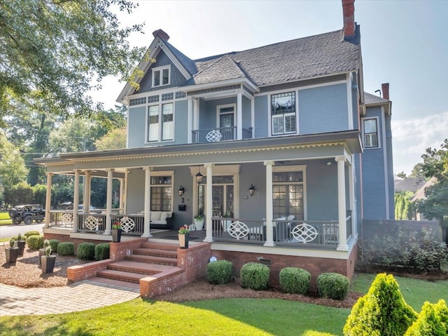 victorian home with covered porch and a front yard