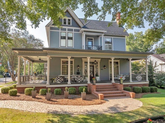 view of front facade with ceiling fan and a porch