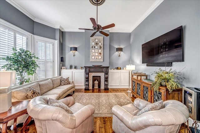 living room with hardwood / wood-style floors, ornamental molding, and a premium fireplace