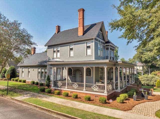 rear view of property featuring a porch