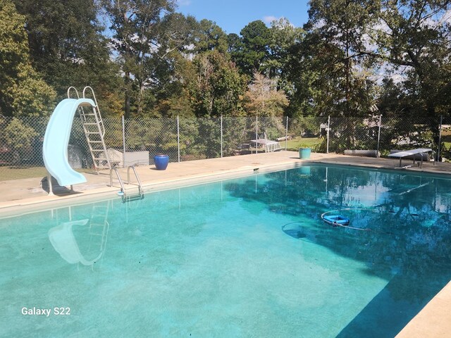 480 Spring Creek Rd, Warwick, GA 31796 - view of pool featuring a water slide, fence, a diving board, and view of wooded area