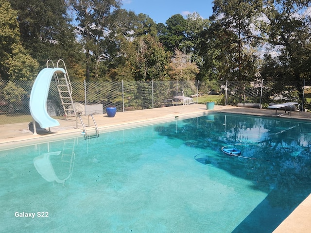 view of pool with a water slide